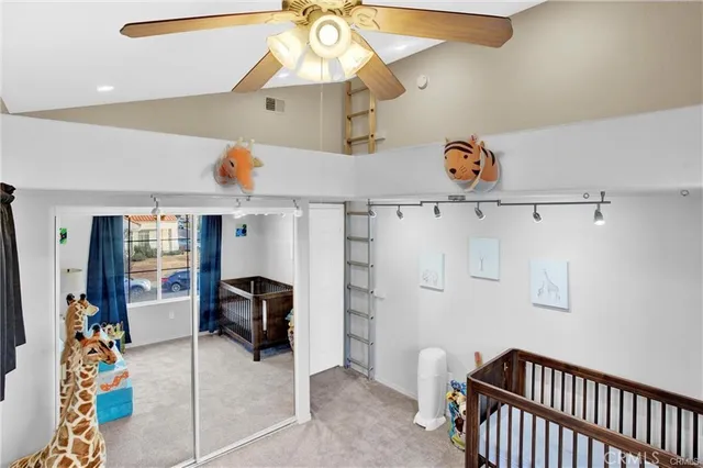 a view of a livingroom with furniture and a ceiling fan