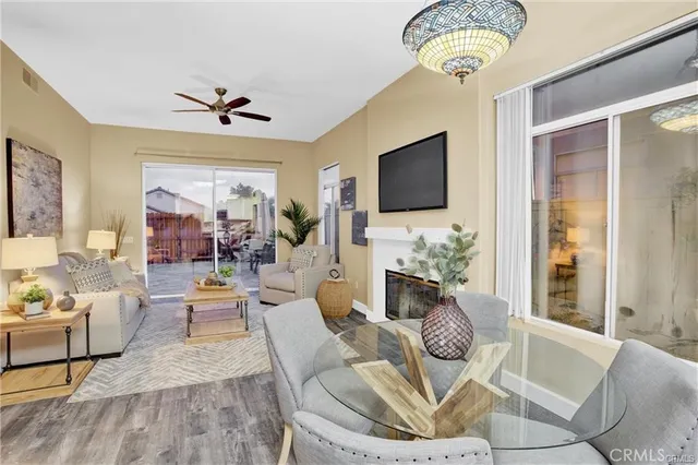 a living room with furniture a fireplace and a flat screen tv