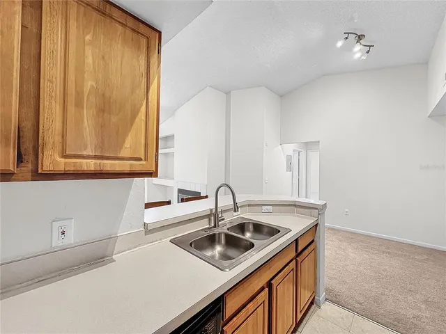 an empty room with a ceiling fan and window