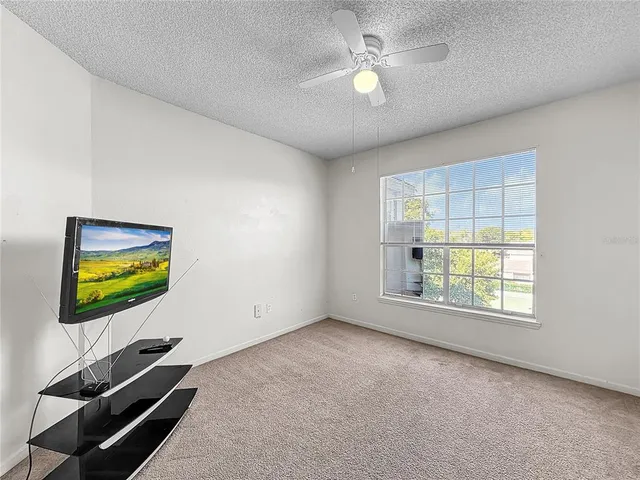 a green field with lots of trees in the background