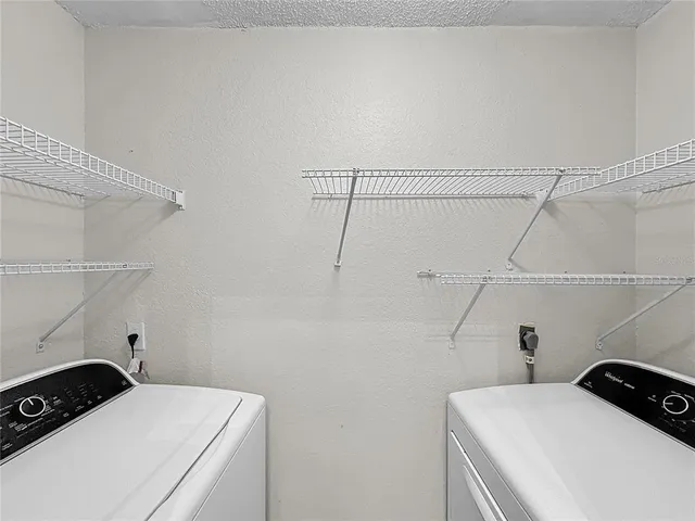 an aerial view of a house with a yard and lake view