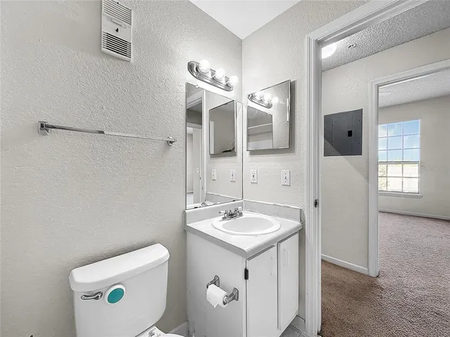 an aerial view of a house with garden space ocean and outdoor seating