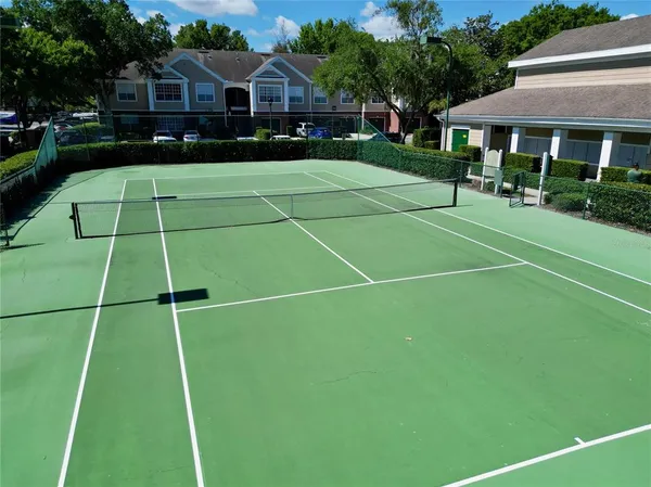 a living room with furniture a fireplace and a large window