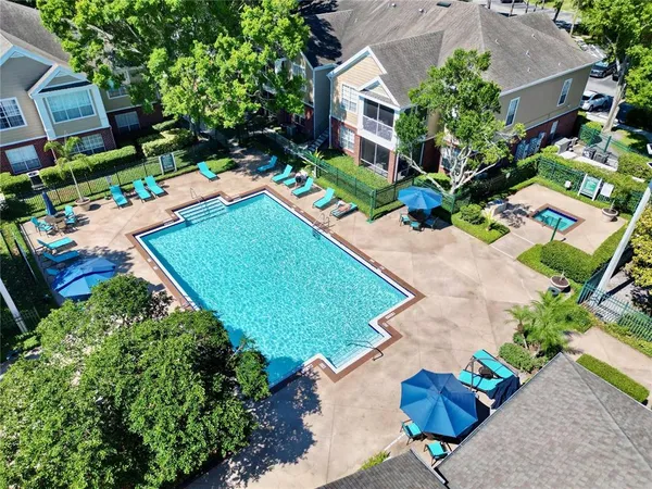 an aerial view of a house with a yard and garden