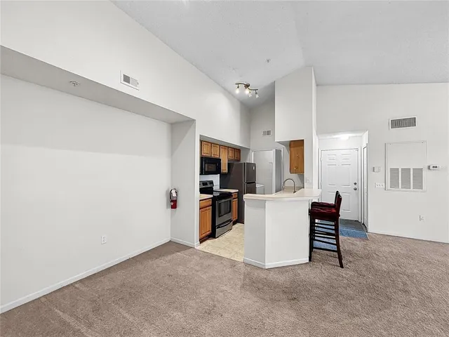 a kitchen with a sink cabinets and window