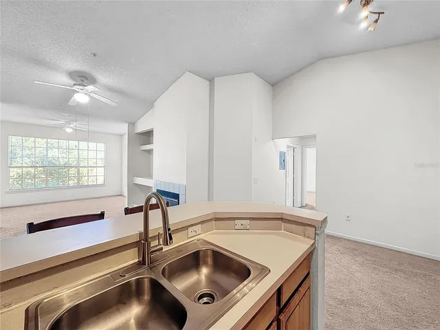 a view of kitchen with stainless steel appliances cabinets and stove