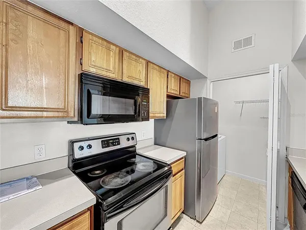 a view of an empty room with a fireplace and a window