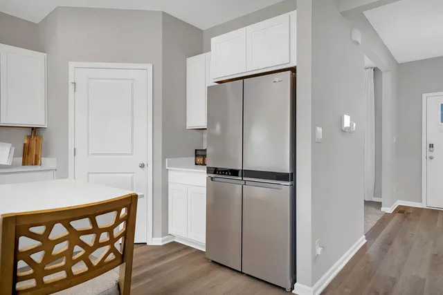 a kitchen with a refrigerator a sink and cabinets