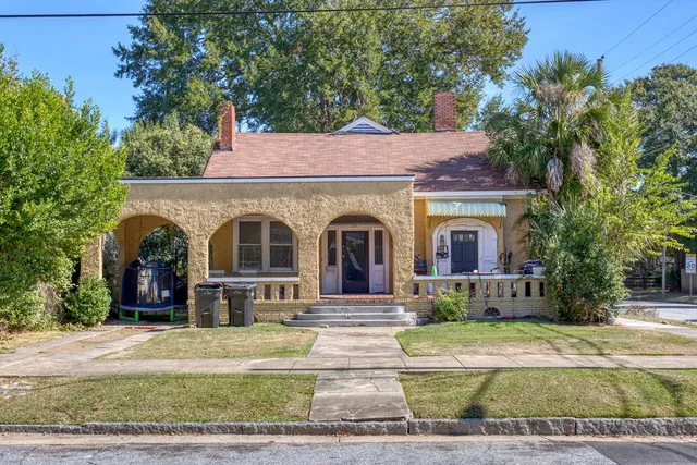 a front view of a house with garden