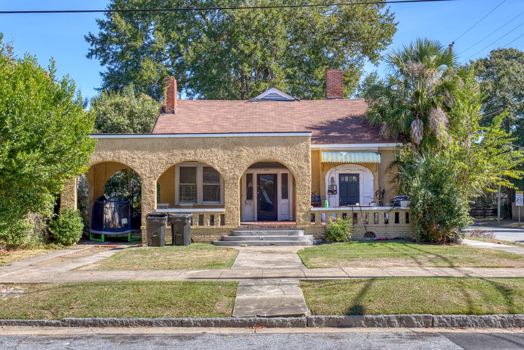 a front view of a house with garden
