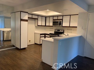 158 South Cross Creek Road, Unit D Orange, CA 92869 - Photo 6 of 7 a kitchen with stainless steel appliances a refrigerator and a stove