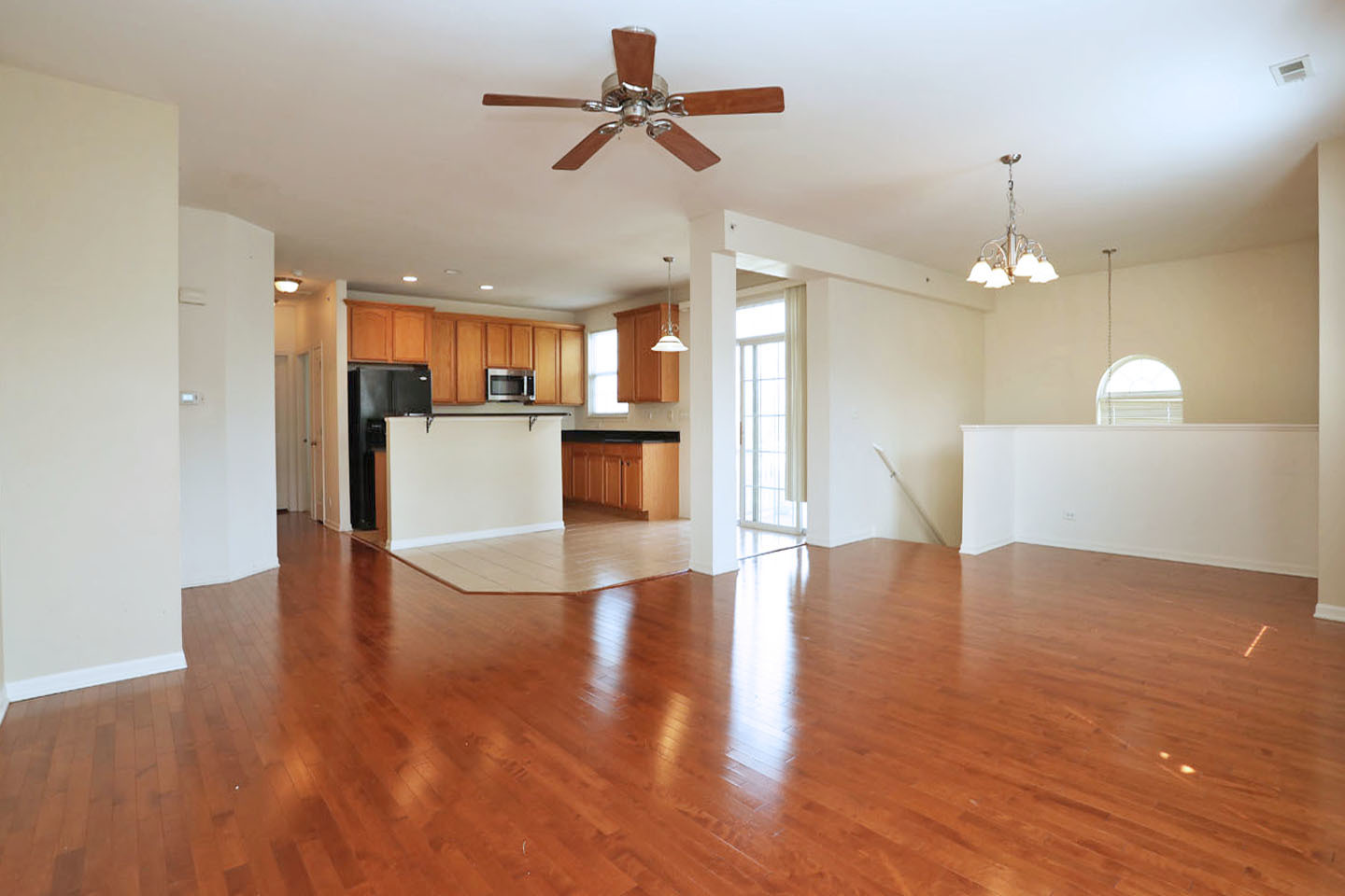 1359 Scarboro Road Schaumburg, IL 60193 - Photo 5 of 21 a view of a kitchen with a sink a refrigerator a fireplace and a chandelier