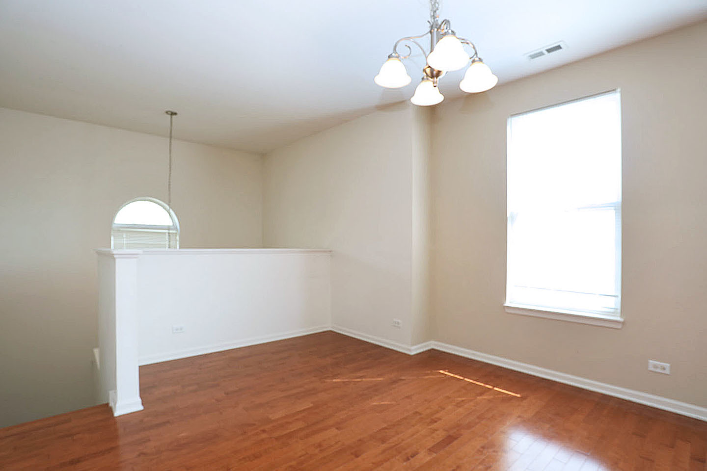 1359 Scarboro Road Schaumburg, IL 60193 - Photo 6 of 21 a view of a room with wooden floor and chandelier