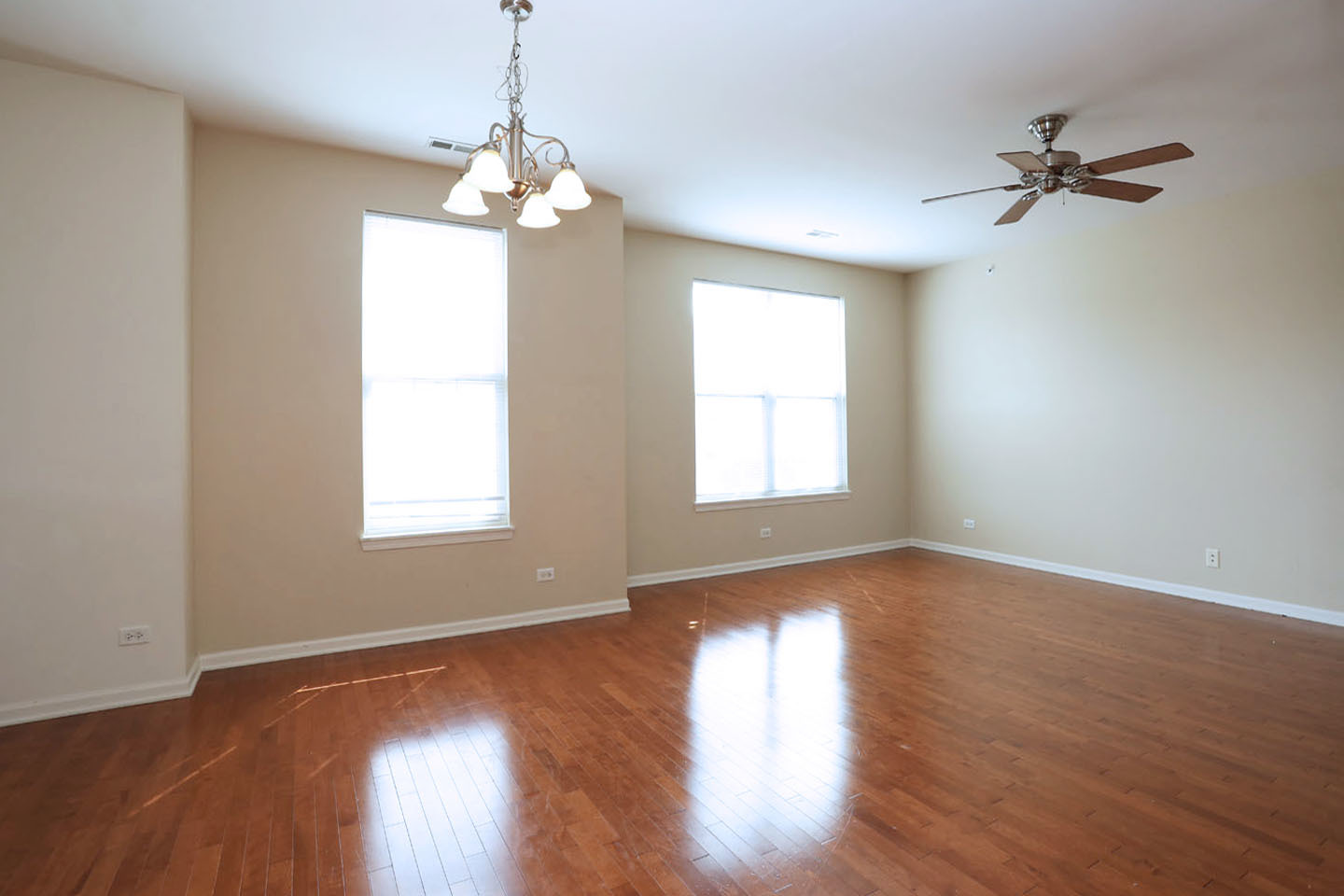 1359 Scarboro Road Schaumburg, IL 60193 - Photo 7 of 21 a view of a room with wooden floor fan and windows