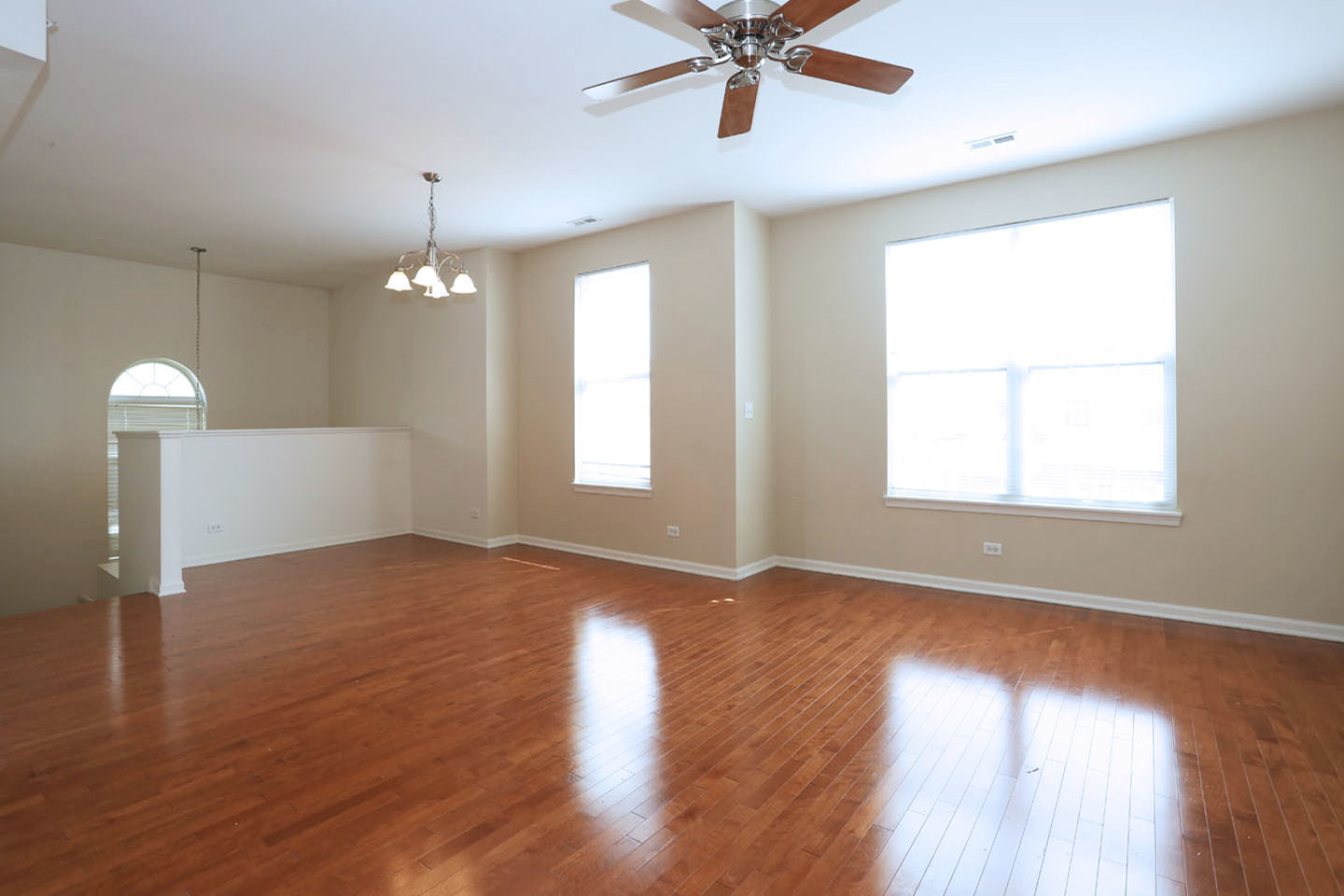 1359 Scarboro Road Schaumburg, IL 60193 - Photo 8 of 21 a view of an empty room with wooden floor and a window