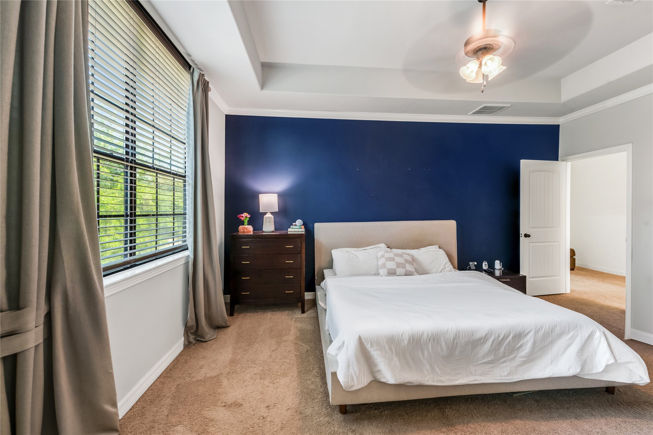 702 Aulia Lane Spring, TX 77386 - Photo 18 of 37 a bedroom with a bed and a chandelier