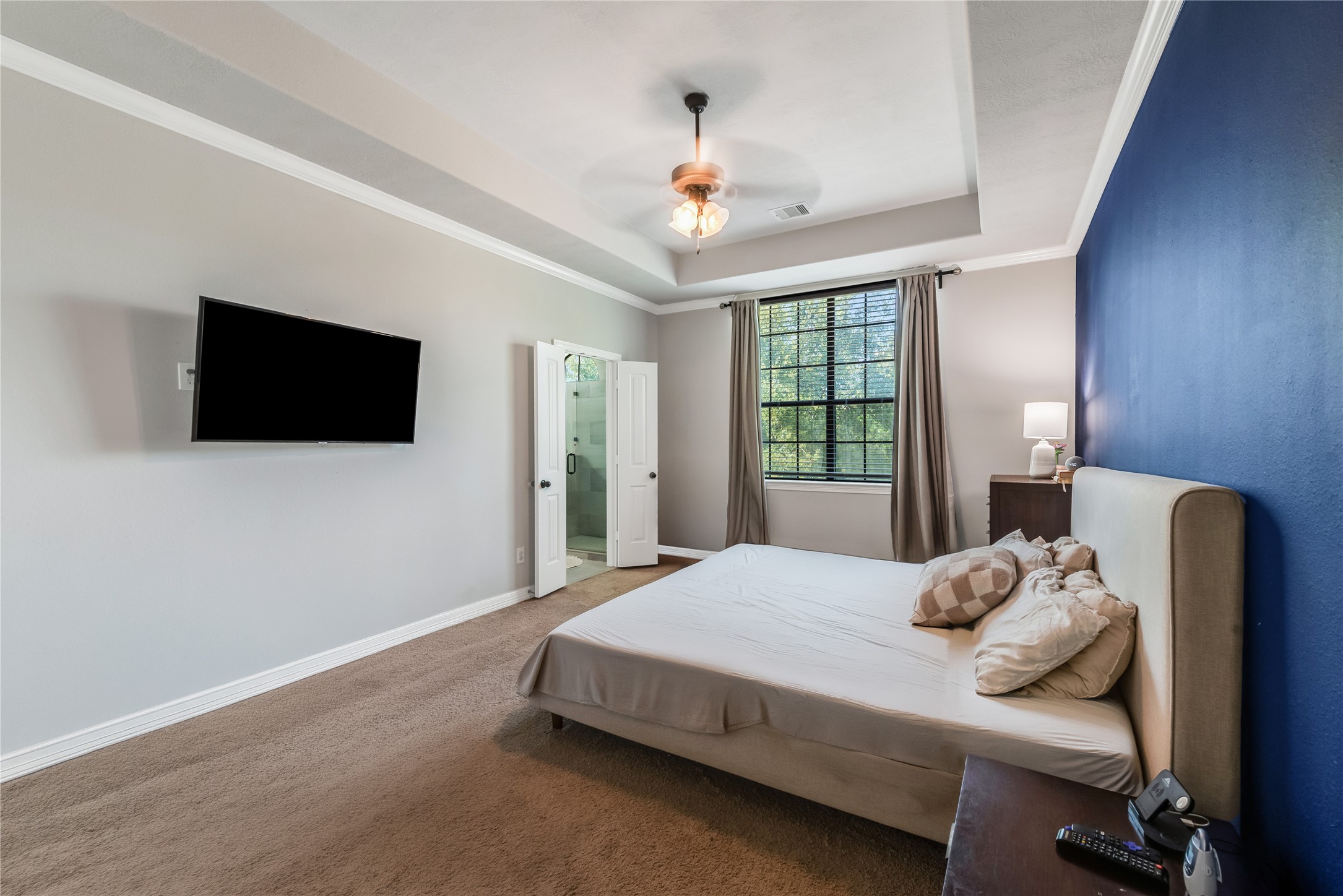 702 Aulia Lane Spring, TX 77386 - Photo 19 of 37 a bedroom with a bed tv and a window