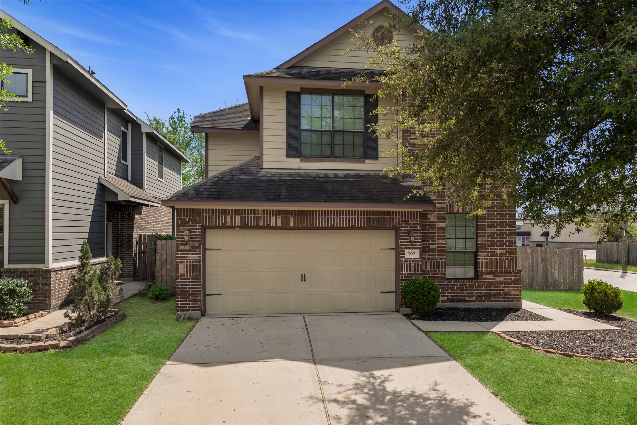 702 Aulia Lane Spring, TX 77386 - Photo 2 of 37 a view of a white house with a small yard and a large tree