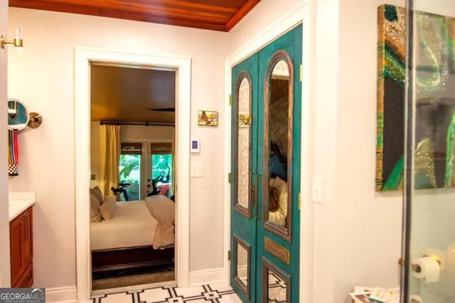 a bedroom with a bed and a chandelier