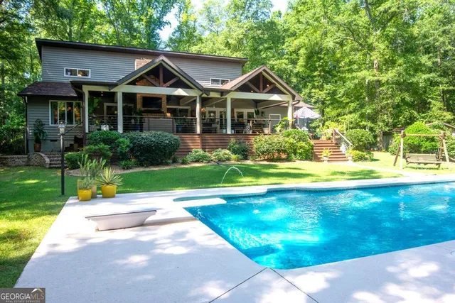 a view of a swimming pool and a yard