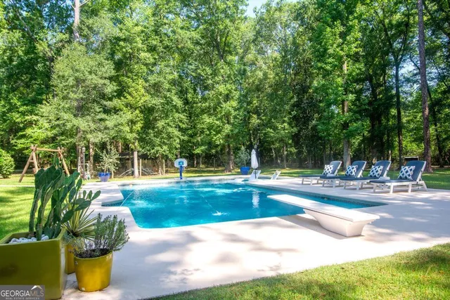 an aerial view of a house with yard swimming pool and outdoor seating