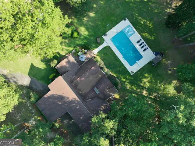 a backyard of a house with yard and outdoor seating