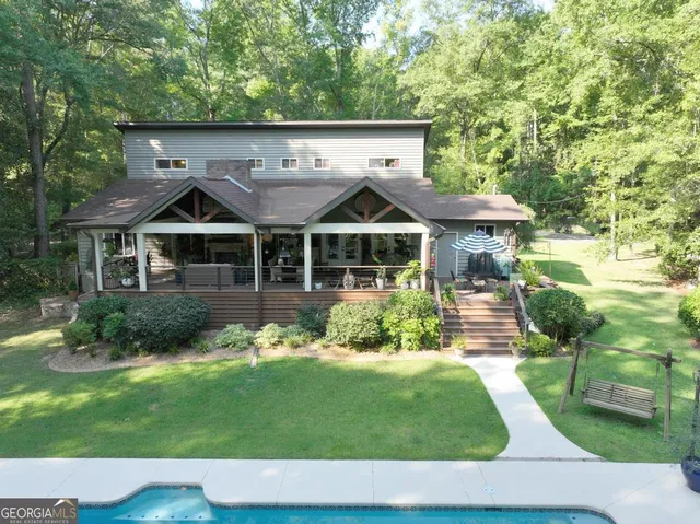 a living room with furniture a potted plant and a table