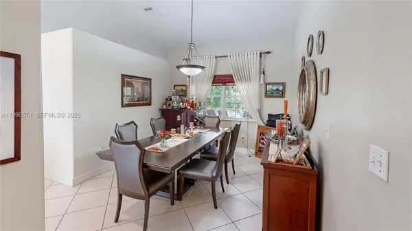 a dining room with furniture and window