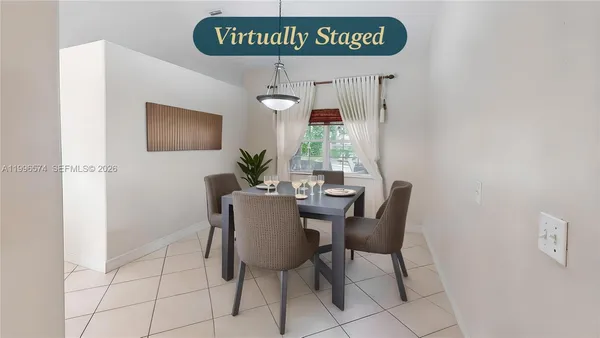 a living room with furniture and view of kitchen