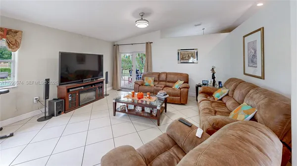 a room with furniture and mirror on the wall