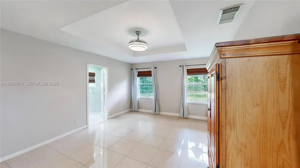a bathroom with a granite countertop double vanity sink mirror and shower