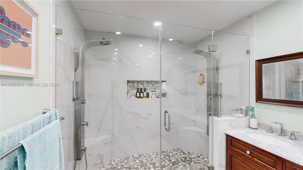 a bedroom with furniture and a large window