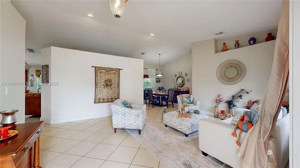 a living room with furniture and a computer on a table