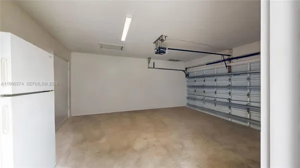 an aerial view of a house with a yard and lake view