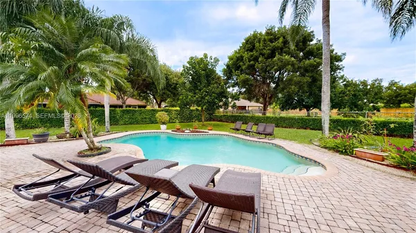 an aerial view of residential houses with outdoor space and street view