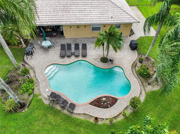 an aerial view of residential houses with outdoor space