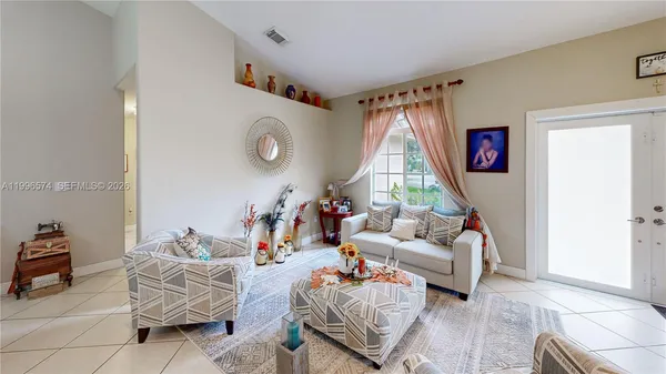a living room with furniture a rug and a window