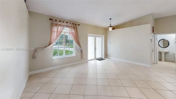 a dining hall with stainless steel appliances granite countertop a dining table and chairs