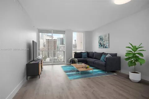 a living room with furniture potted plant and a window
