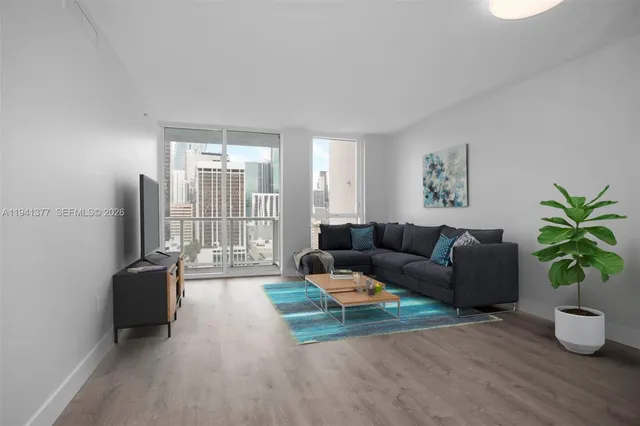 a living room with furniture potted plant and a window