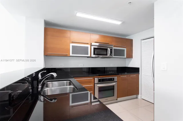 a kitchen that has a sink and cabinets