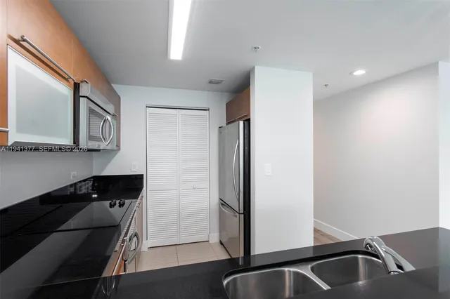 a view of a kitchen with a sink and dishwasher