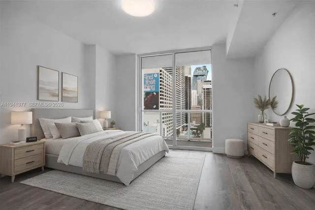 a bedroom with bed and wooden floor