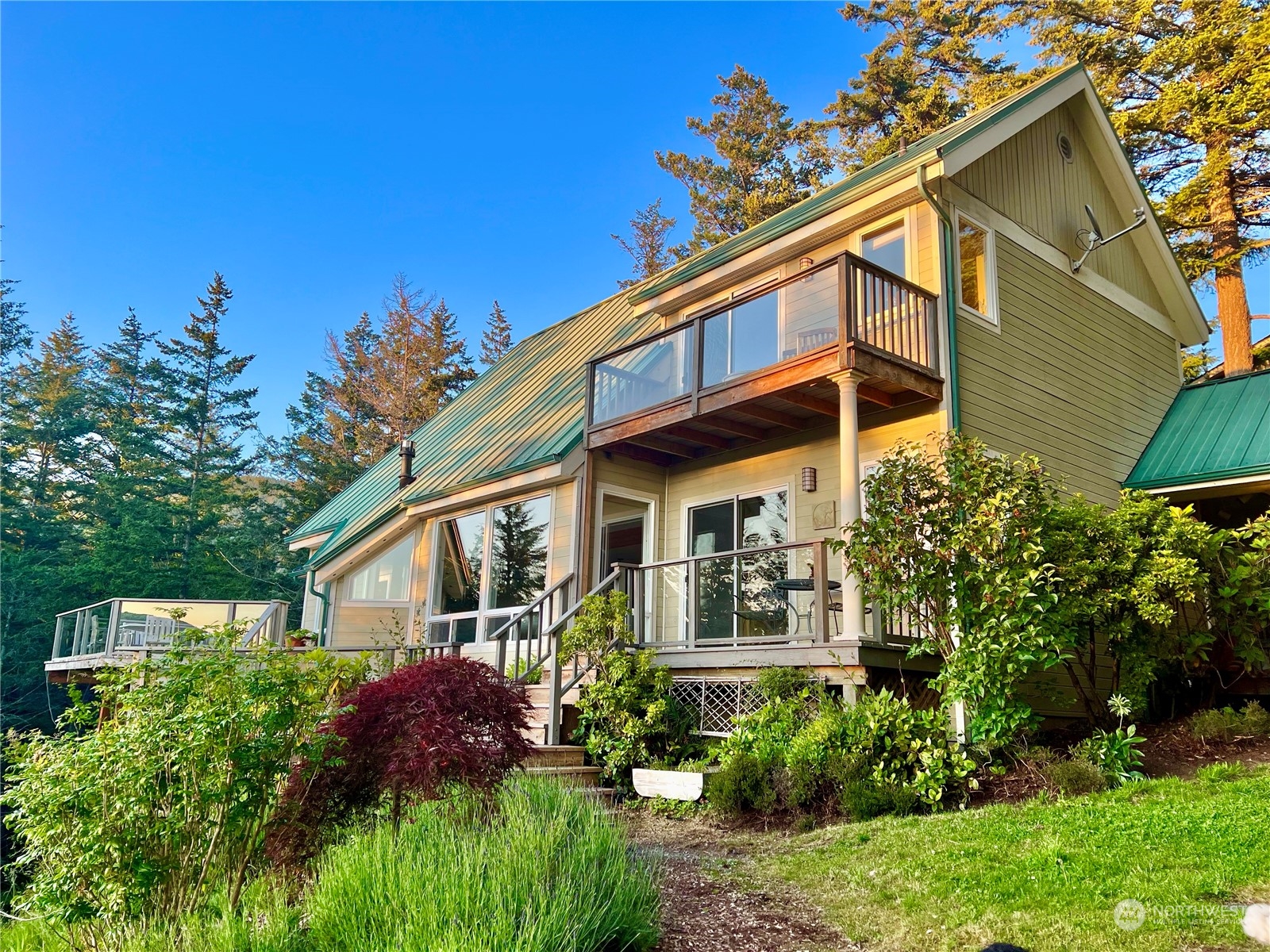 381 Geiser Way Orcas Island, WA 98245 - Photo 4 of 40 a front view of a house with garden