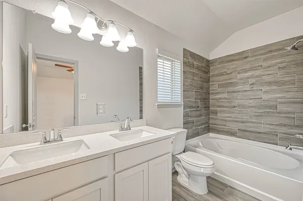 a view of a house with a yard and fence