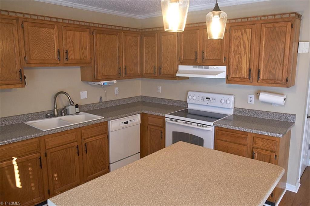 1012 Springwood Lane Archdale, NC 27370 - Photo 13 of 46 There's lots of cabinet space, plus an island for more prep space and storage.