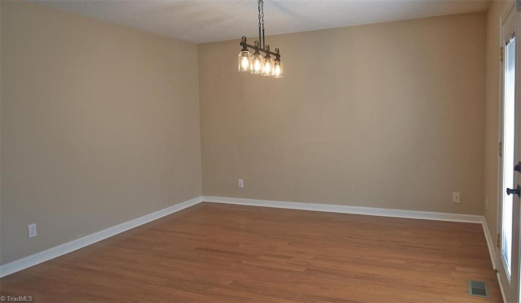 1012 Springwood Lane Archdale, NC 27370 - Photo 15 of 46 Huge dining room is open to the kitchen and has French doors leading out to 16 x 10 deck. Updated lighting.
