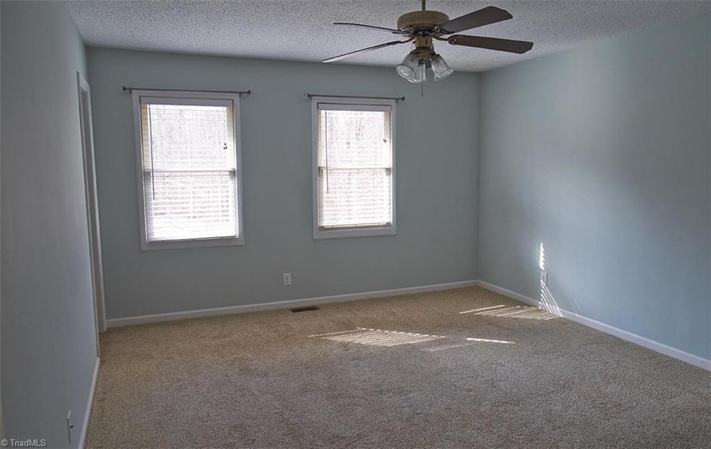 1012 Springwood Lane Archdale, NC 27370 - Photo 23 of 46 Primary bedroom has faux wood venetian blinds.