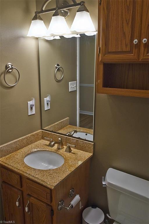 1012 Springwood Lane Archdale, NC 27370 - Photo 35 of 46 Hall bathroom has oak cabinets, granite counter top, and nice pewter fixtures and lighting.