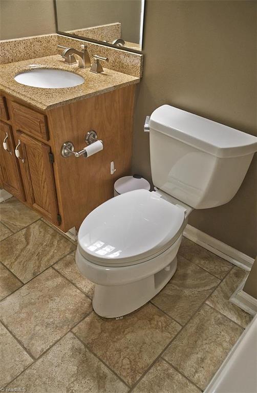 1012 Springwood Lane Archdale, NC 27370 - Photo 36 of 46 Hall bathroom has a Kohler toilet and glazed porcelain tile floors.